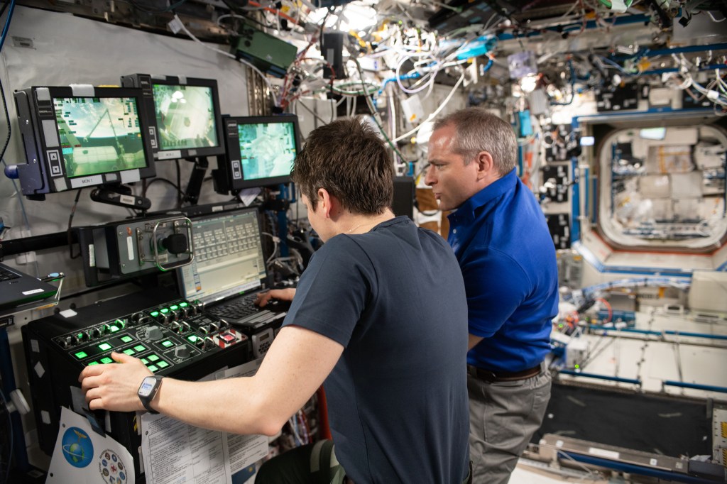 Expedition 59 Flight Engineers Anne McClain and David Saint-Jacques use the robotics workstation inside the U.S. Destiny laboratory module to practice Canadarm2 robotics maneuvers and Cygnus spacecraft capture techniques.