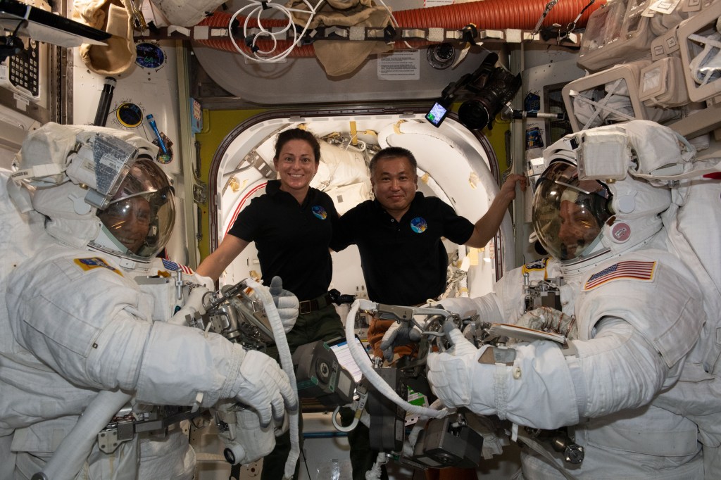 iss068e026320 (Dec. 3, 2022) --- Flight Engineers Nicole Mann (center left) of NASA and Koichi Wakata (center right) of the Japan Aerospace Exploration Agency (JAXA) pose with NASA spacewalkers Frank Rubio (far left) and Josh Cassada (far right) who are suited up and ready to begin a spacewalk to install a roll-out solar array on the International Space Station's Starboard-4 truss segment.