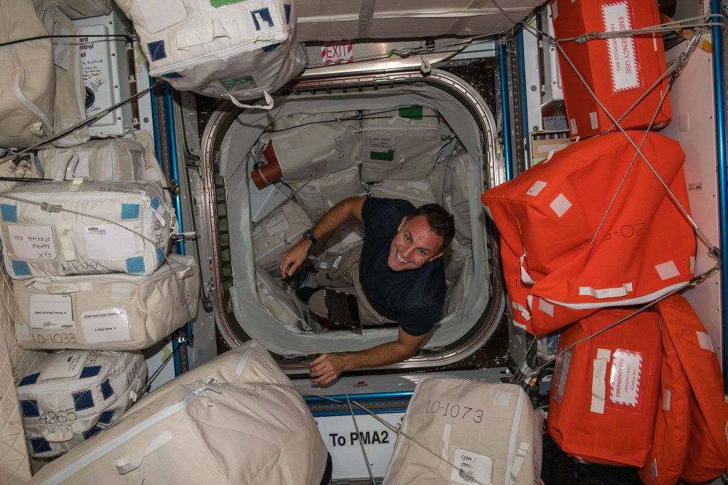 iss068e020515 (Nov. 3, 2022) --- NASA astronaut and Expedition 68 Flight Engineer Josh Cassada is pictured inside the Harmony module's forward-facing international docking adapter where the SpaceX Dragon Endeavour crew ship is docked.