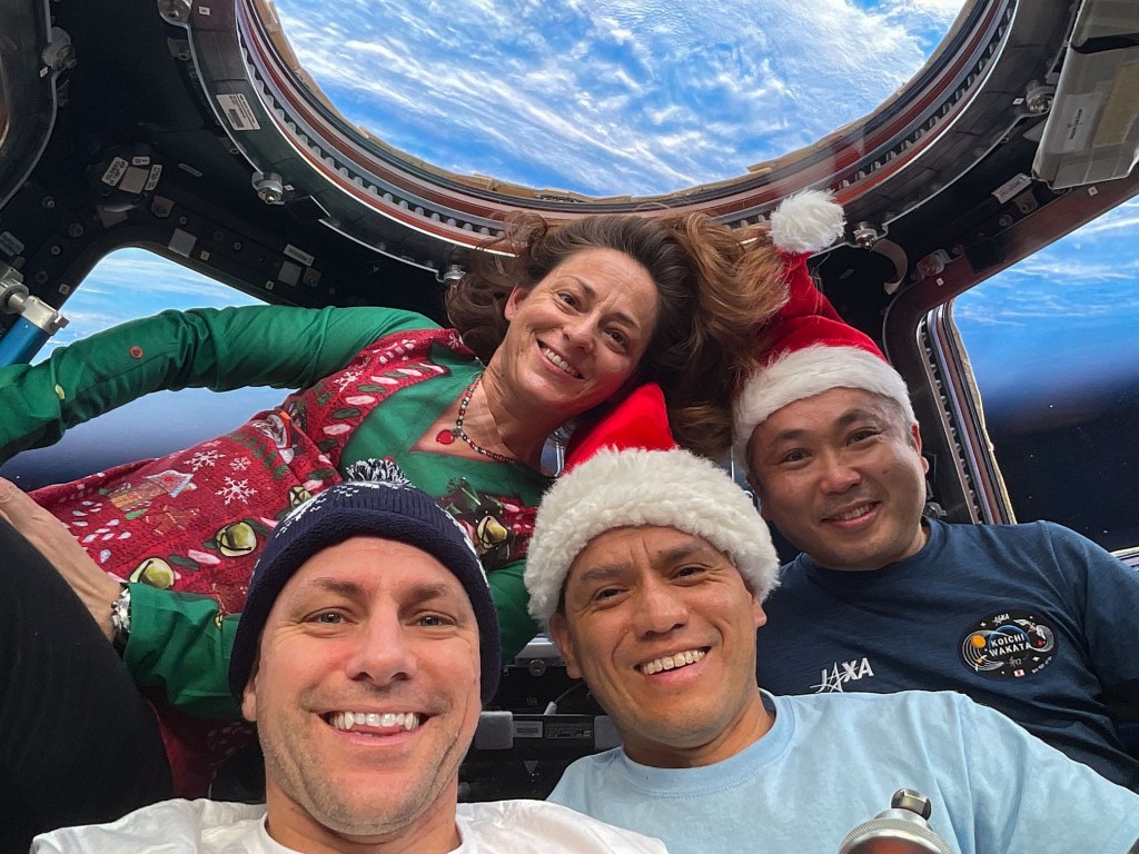 iss068e032486 (Dec. 25, 2022) --- Expedition 68 Flight Engineers (from left) Josh Cassada, Nicole Mann, and Frank Rubio, all from NASA, and Koichi Wakata of the Japan Aerospace Exploration Agency (JAXA), pose for a festive portrait on Christmas Day inside the cupola as the International Space Station orbited 270 miles above the southern Atlantic Ocean.