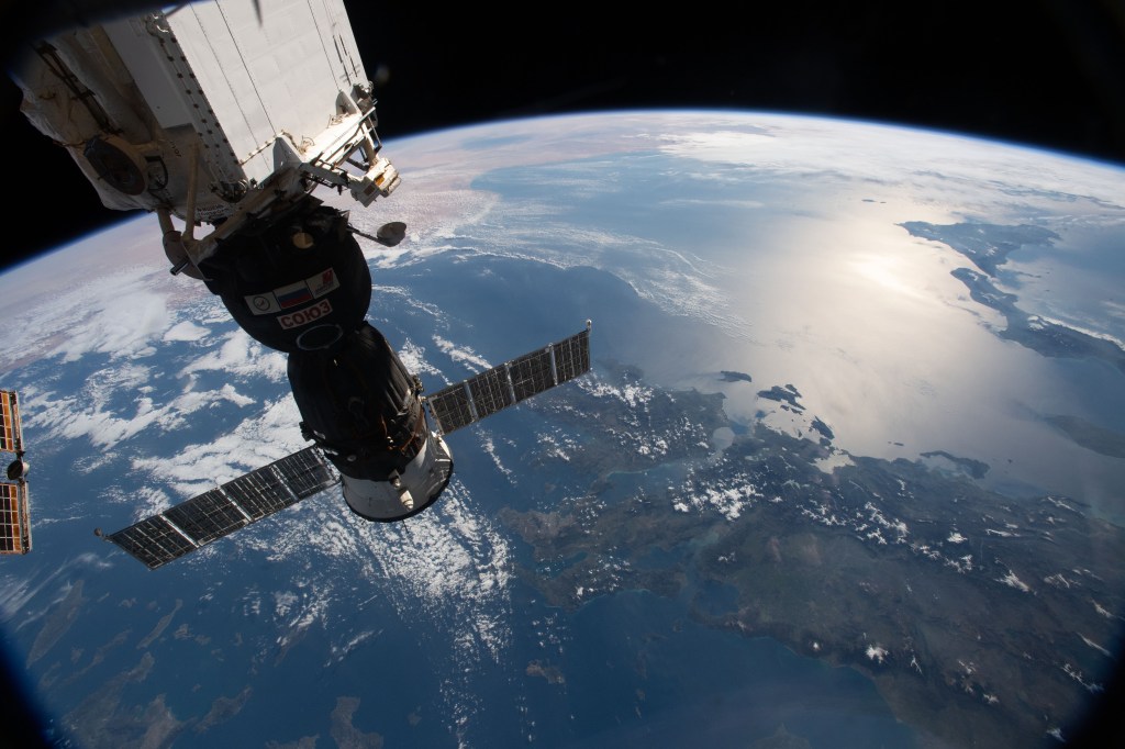 The Soyuz MS-12 spacecraft is pictured docked to the International Space Station's Rassvet module as the orbital complex flew 256 miles above the Aegean Sea. This view looks from northeast to southwest, from Greece, Italy and across the Mediterranean Sea to Libya.