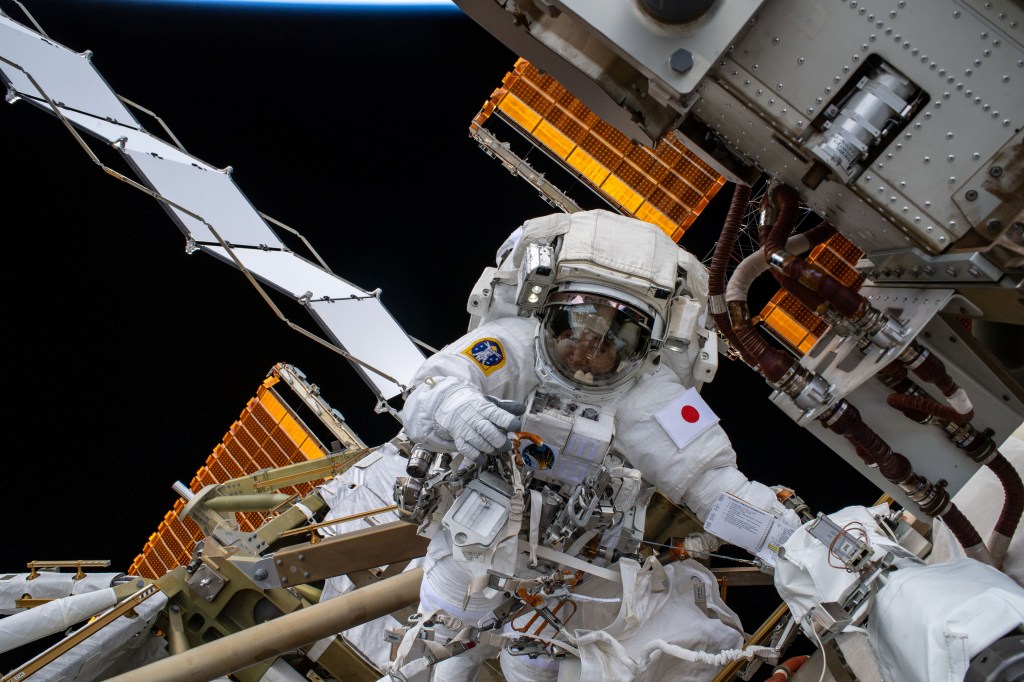 iss068e045124 (Feb. 2, 2023) --- Expedition 68 Flight Engineer Koichi Wakata of the Japan Aerospace Exploration Agency (JAXA) is pictured in his Extravehicular Mobility Unit, or spacesuit, during his second spacewalk. He and fellow spacewalker Nicole Mann (out of frame) of NASA installed a modification kit on the International Space Station's starboard truss structure that will enable the future installation of the orbiting lab's next roll-out solar array.