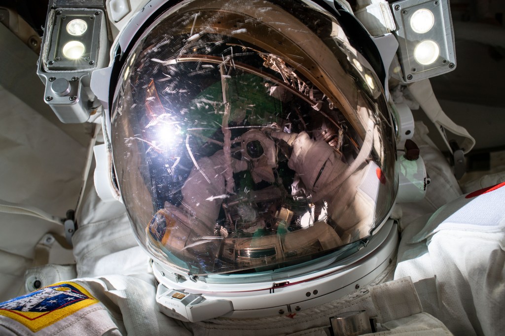 iss068e045263 (Feb. 2, 2023) --- Expedition 68 Flight Engineer Koichi Wakata of the Japan Aerospace Exploration Agency (JAXA) points the camera toward himself and takes a "space-selfie" during a six-hour and 41-minute spacewalk. He and fellow spacewalker Nicole Mann (out of frame) of NASA installed a modification kit on the International Space Station's starboard truss structure preparing the orbital lab for its next roll-out solar array.