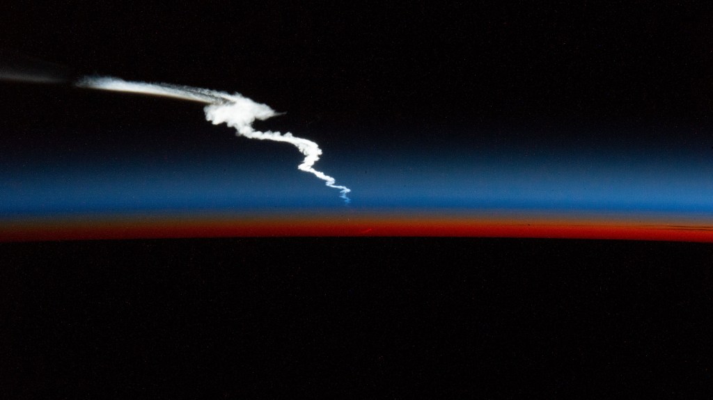 An external high-definition camera on the International Space Station captured the launch plume of the SpaceX Falcon Heavy rocket after it had ascended to Earth orbit following its liftoff on Sunday, Jan. 15, 2023, from NASA's Kennedy Space Center in Florida. The space station was flying 262 miles above the Atlantic Ocean just after an orbital sunset at the time of this photograph.