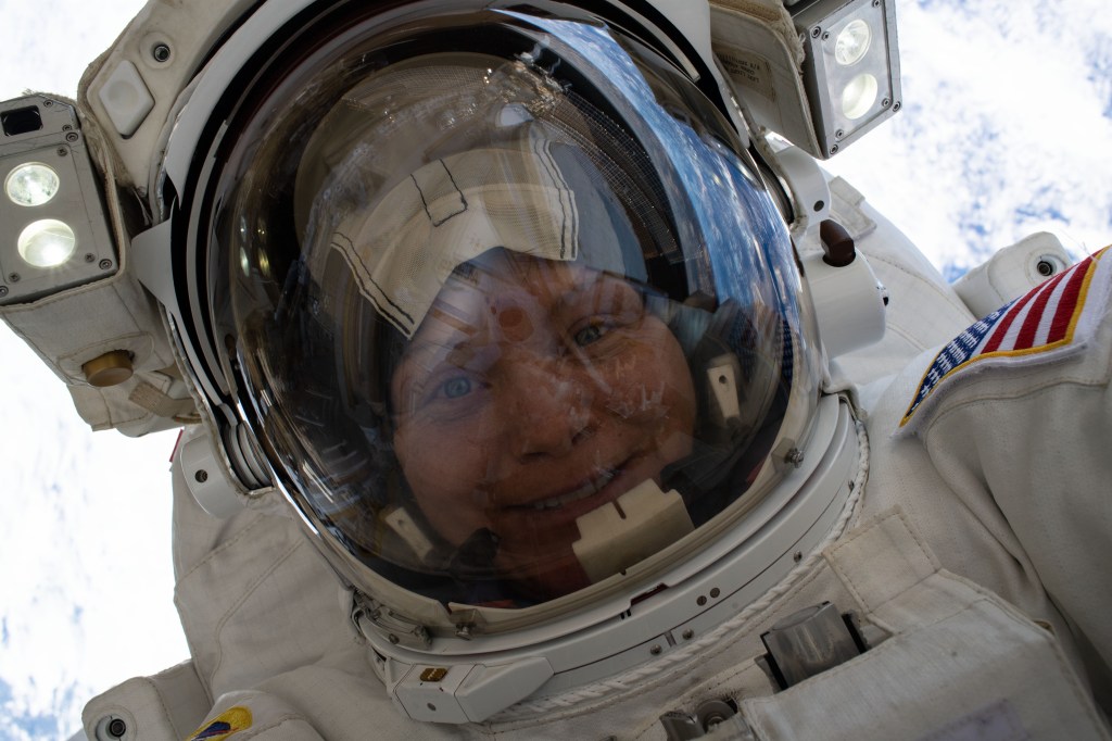 NASA astronaut Anne McClain takes a "space-selfie" with her helmet visor up 260 miles above the Earth's surface during a six-hour, 39-minute spacewalk to upgrade the orbital complex's power storage capacity.
