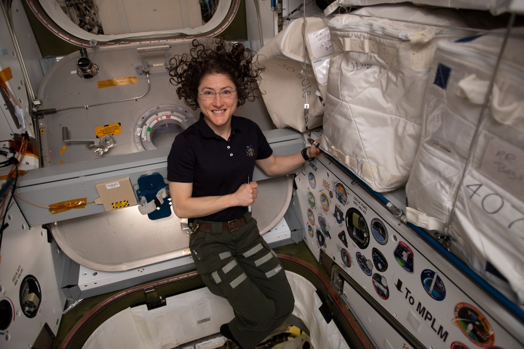 NASA astronaut Christina Koch poses for a portrait inside of the vestibule between the SpaceX Dragon cargo craft and the Harmony module. The hatch to Dragon was later closed and the resupply ship detached from Harmony before it was released from the grips of the Canadarm2 robotic arm. Dragon spent nearly a month attached to the International Space Station.