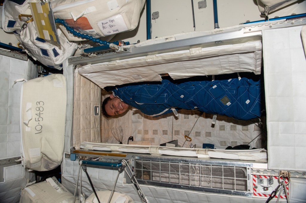 iss068e065074 (March 2, 2023) --- NASA astronaut and Expedition 68 Flight Engineer Josh Cassada is pictured bundled up in his crew quarters aboard the International Space Station.