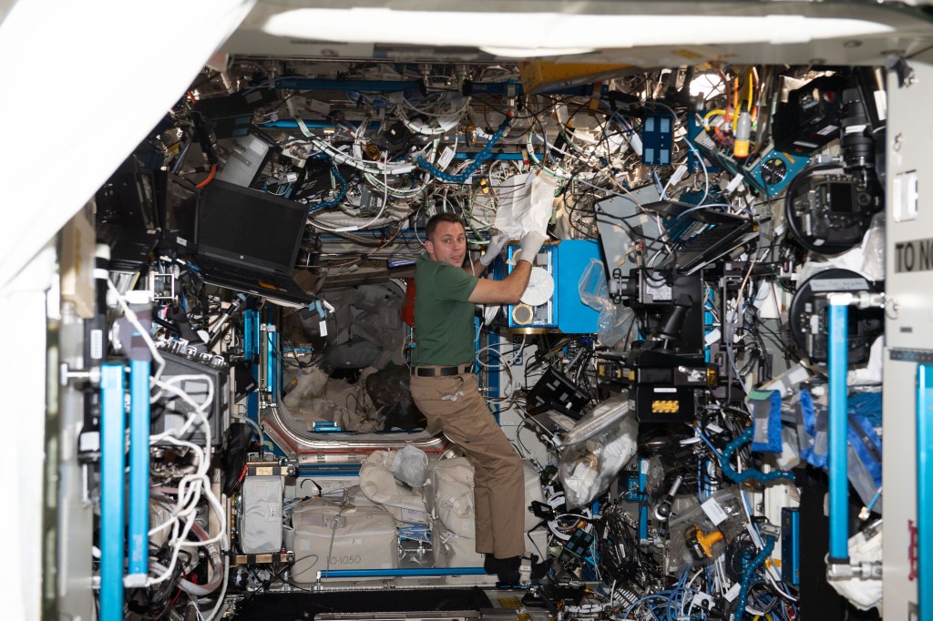 iss068e033456 (Dec. 27, 2022) --- Expedition 68 Flight Engineer and NASA astronaut Josh Cassada is pictured cleaning hardware inside the International Space Station's Destiny laboratory module.