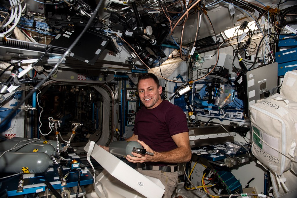iss068e023646 (Nov. 21, 2022) --- NASA astronaut and Expedition 68 Flight Engineer Josh Cassada works inside the International Space Station's Harmony module replacing carbon dioxide bottles that support space botany research inside the Plant Habitat.