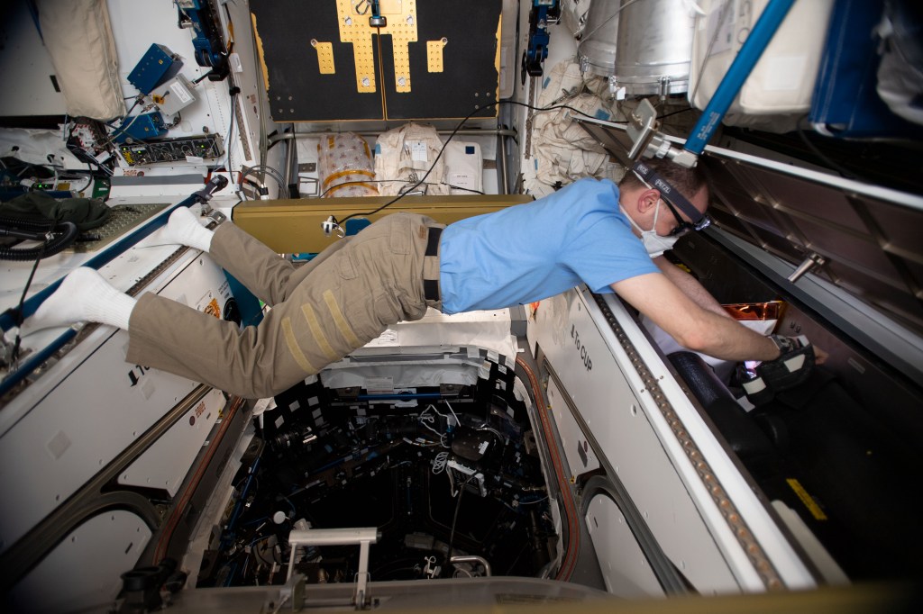 NASA astronaut Nick Hague of Expedition 59 installs gas trap plugs inside the Tranquility module's Moderate Temperature Loop Pump Package Assembly. The gas trap plugs would slow an ammonia release through the gas trap vent hole in the event of an Interface Heat Exchanger breach and reduce coolant leakage during vacuum conditions at the International Space Station.