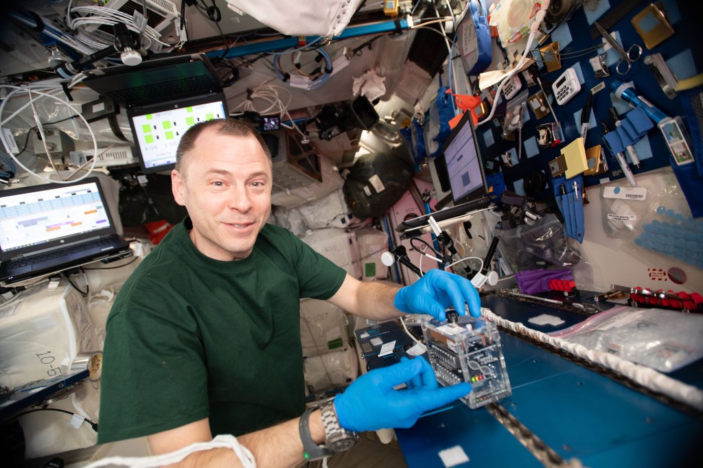 NASA astronaut Nick Hague works with the miniPCR hardware inside the Columbus laboratory module for the Genes In Space-6 experiment that is exploring how space radiation damages DNA and how the cell repair mechanism works in microgravity.