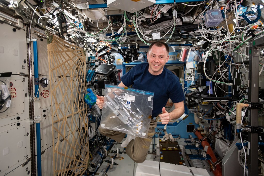 NASA astronaut Nick Hague is photographed with the CASIS PCG-14 investigation in the Destiny module of the International Space Station (ISS). The Wisconsin Crystal Growing Contest-Wisconsin Space Crystals (CASIS PCG 14) teaches middle and high school students the unique engineering research and operations of the space program. The investigation allows students to understand the capabilities and constraints of conducting an experiment in microgravity.