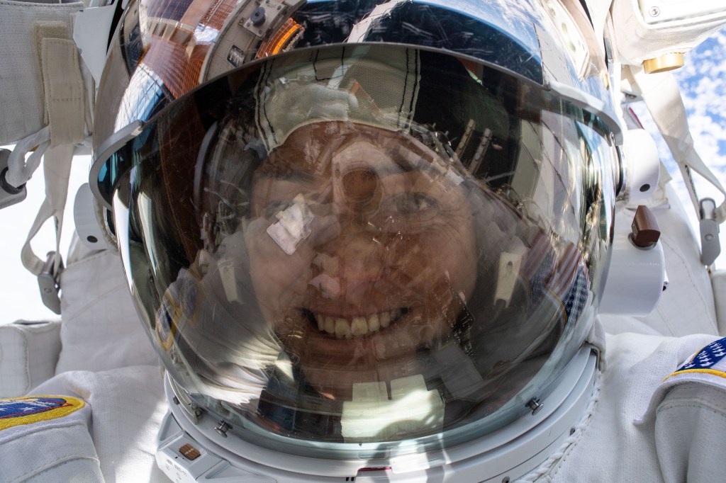 iss068e045117 (Feb. 2, 2023) --- NASA astronaut and Expedition 68 Flight Engineer Nicole Mann points the camera toward herself and takes a "space-selfie" with her helmet's visor up during a six-hour and 41-minute spacewalk. She and fellow spacewalker Koichi Wakata (out of frame) of the Japan Aerospace Exploration Agency (JAXA) installed a modification kit on the International Space Station's starboard truss structure preparing the orbital lab for its next roll-out solar array.