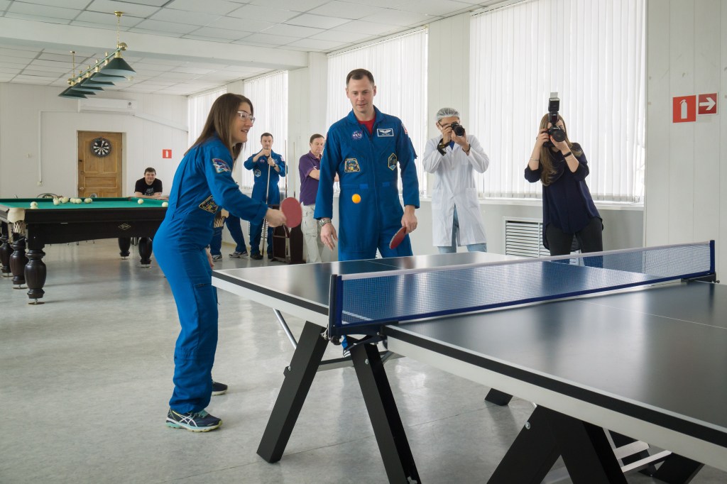 At their Cosmonaut Hotel crew quarters in Baikonur, Kazakhstan, Expedition 59 crew members Christina Koch of NASA (left) and Nick Hague of NASA (right) play a game of ping-pong March 7 as they take a break from pre-launch training. Along with Alexey Ovchinin of Roscosmos, they will launch March 14, U.S. time, on the Soyuz MS-12 spacecraft from the Baikonur Cosmodrome for a six-and-a-half month mission on the International Space Station.