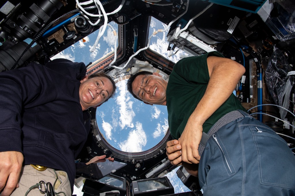 iss068e020602 (Nov. 3, 2022) --- NASA astronauts Nicole Mann and Frank Rubio are pictured inside the seven window cupola, the International Space Station's "window to the world," while orbiting 272 miles above the south Atlantic Ocean.