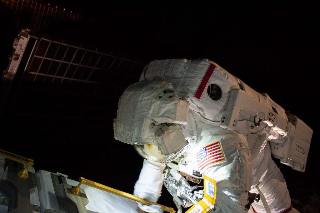 NASA astronaut Anne McClain works on the International Space Station's Port-4 truss structure during a six-hour, 39-minute spacewalk to upgrade the orbital complex's power storage capacity.