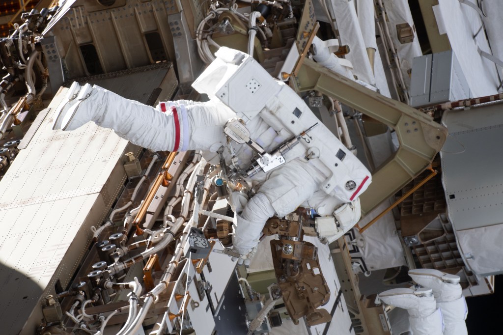 NASA spacewalker Anne McClain works on the International Space Station's Port-4 truss structure during a six-hour, 39-minute spacewalk to upgrade the orbital complex's power storage capacity.
