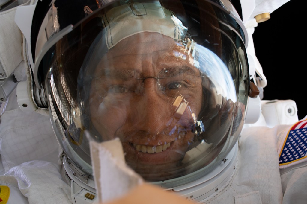 iss068e022445 (Nov. 15, 2022) --- NASA astronaut and Expedition 68 Flight Engineer Frank Rubio points his camera toward himself and takes an out-of-this-world "space-selfie" with his helmet visor's reflective shield up during a spacewalk in his Extravehicular Mobility Unit, or spacesuit.