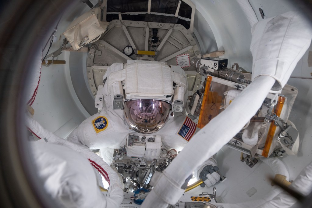 NASA spacewalker Nick Hague exits the crew lock portion of the U.S. Quest airlock beginning a spacewalk to upgrade the International Space Station's power storage capacity. This was Hague's and NASA astronaut Anne McClain's (out of frame) first spacewalk.