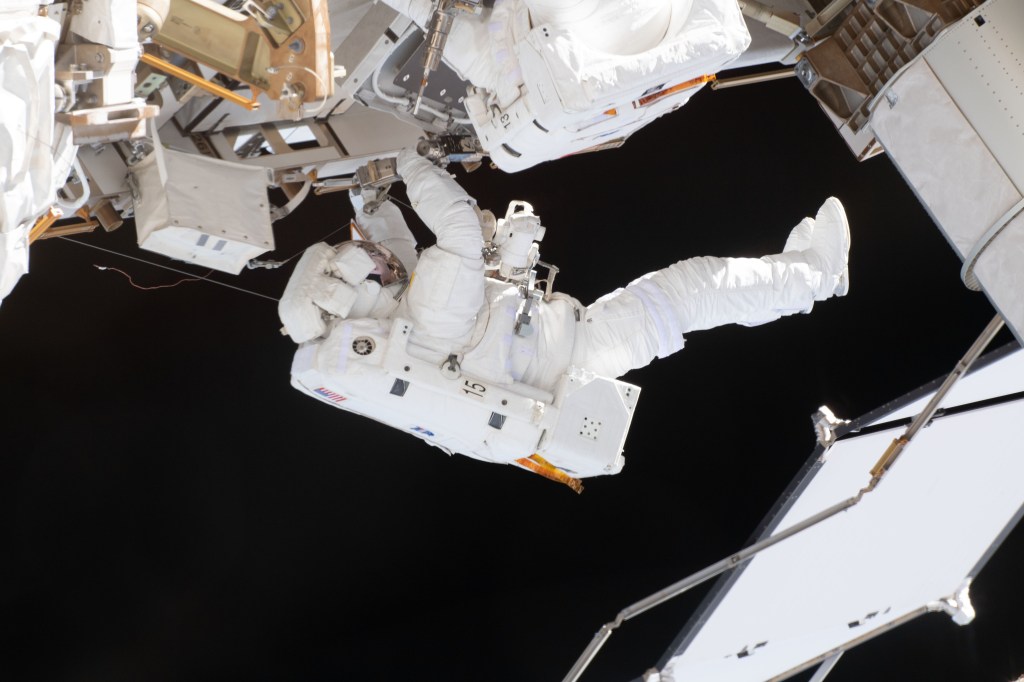 NASA spacewalker Nick Hague, in his white U.S. spacesuit with no stripes, is contrasted by the blackness of space during a six-hour, 39-minute spacewalk to upgrade the International Space Station's power storage capacity. This was Hague's and NASA astronaut Anne McClain's (out of frame) first spacewalk.