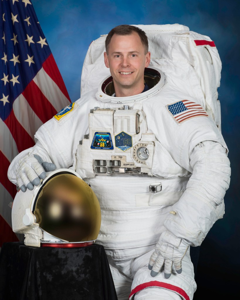 Official portrait of NASA astronaut Nick Hague in a U.S. spacesuit, also known as an Extravehicular Mobility Unit (EMU).