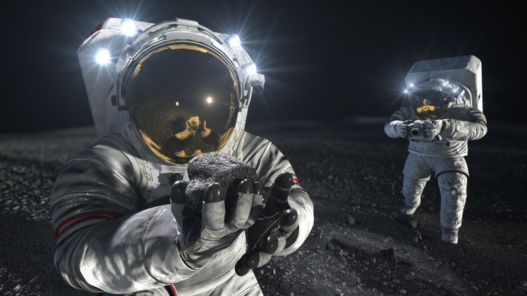 In this concept image, two suited astronauts explore on the lunar surface. The astronaut in the foreground holds a sample toward the camera, while the other in the background takes a picture with a camera of a sample on the ground.