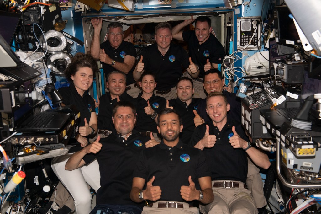 iss068e069112 (March 6, 2023) --- The 11-member crew aboard the International Space Station give thumbs up signs in this portrait. In the bottom row from left are Flight Engineers Andrey Fedyaev of Roscosmos, Sultan Alneyadi from UAE (United Arab Emirates), and Woody Hoburg from NASA. In the middle row from left are Flight Engineers Anna Kikina from Roscosmos, Koichi Wakata from JAXA (Japan Aerospace Exploration Agency), Nicole Mann from NASA, Dmitri Petelin from Roscosmos, and Frank Rubio from NASA. In the back are Flight Engineer Stephen Bowen from NASA, Commander Sergey Prokopyev from Roscosmos, and Flight Engineer Josh Cassada from NASA.