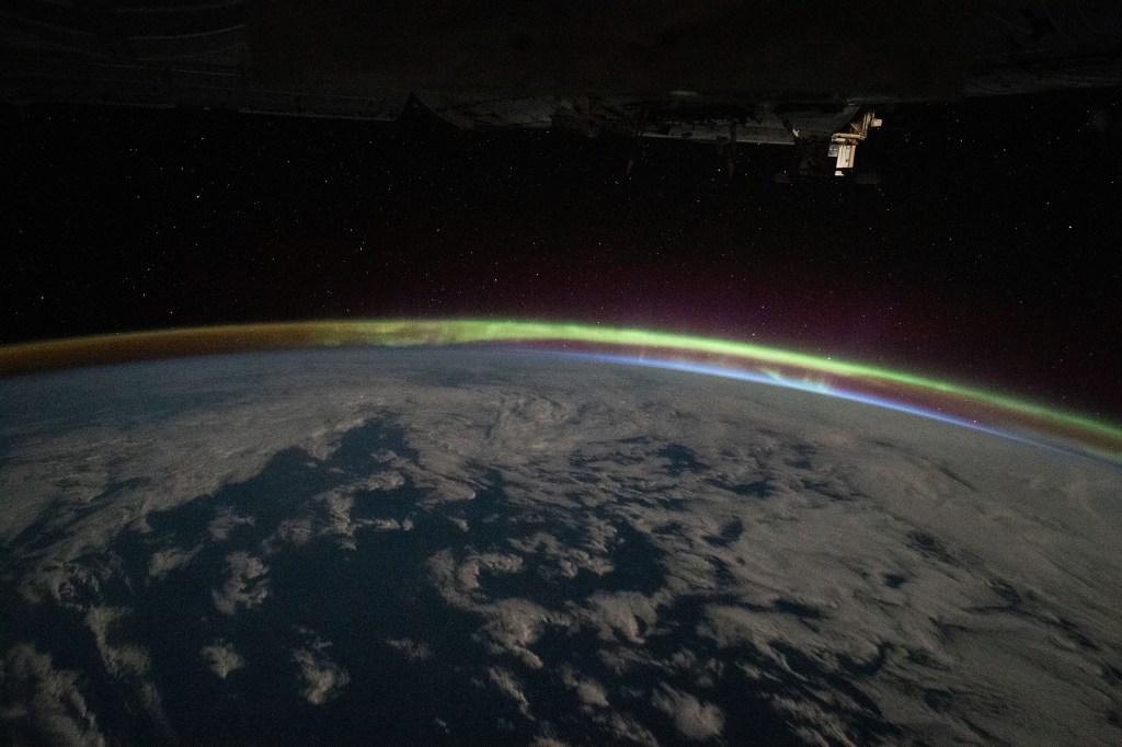 iss068e010113 (Oct. 4, 2022) --- The aurora australis intersects Earth's atmospheric glow in this photograph from the International Space Station as it orbited 268 miles above the Indian Ocean southeast of South Africa.