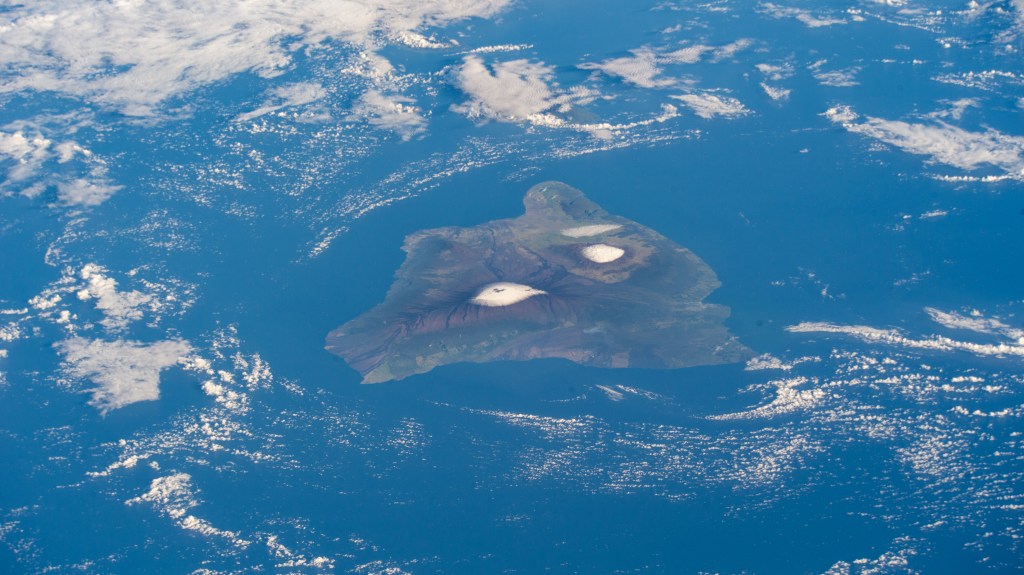 The big island of Hawaii and its two snow-capped volcanos, (from left) the active Mauna Loa and the dormant Mauna Kea, are pictured from the International Space Station as it orbited 260 miles above the Pacific Ocean.
