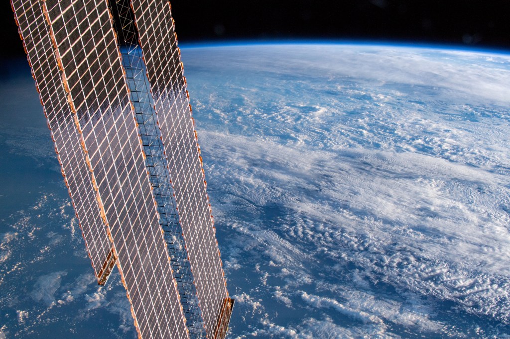 261 miles above Earth and off the coast of the Australian cities of Gold Coast and Brisbane, an Expedition 59 crew member photographed the cloud-covered Tasman and Coral Seas. A portion of the International Space Station's solar arrays drape over the Earth as the orbital lab passes over the terminator, the line that separates night from day.