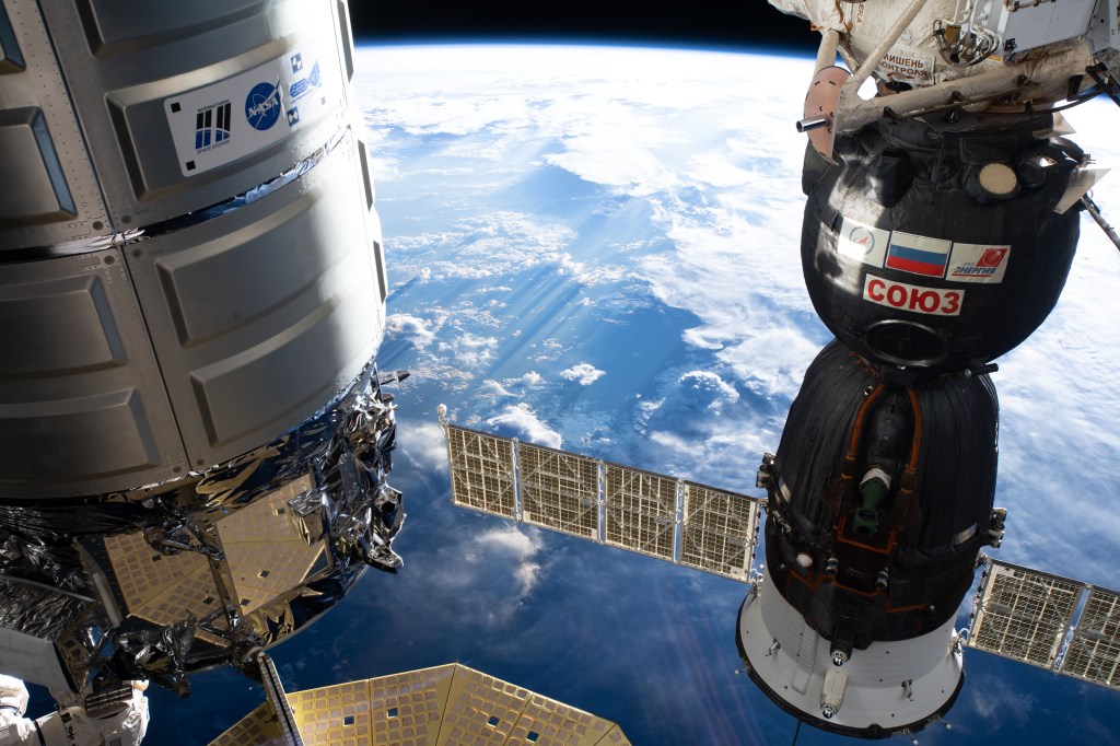 The Northrop Grumman Cygnus space freighter (left) from the United States and the Roscosmos Soyuz MS-12 crew ship from Russia are pictured attached to the International Space Station as the orbital complex flew 256 miles above Brazil.
