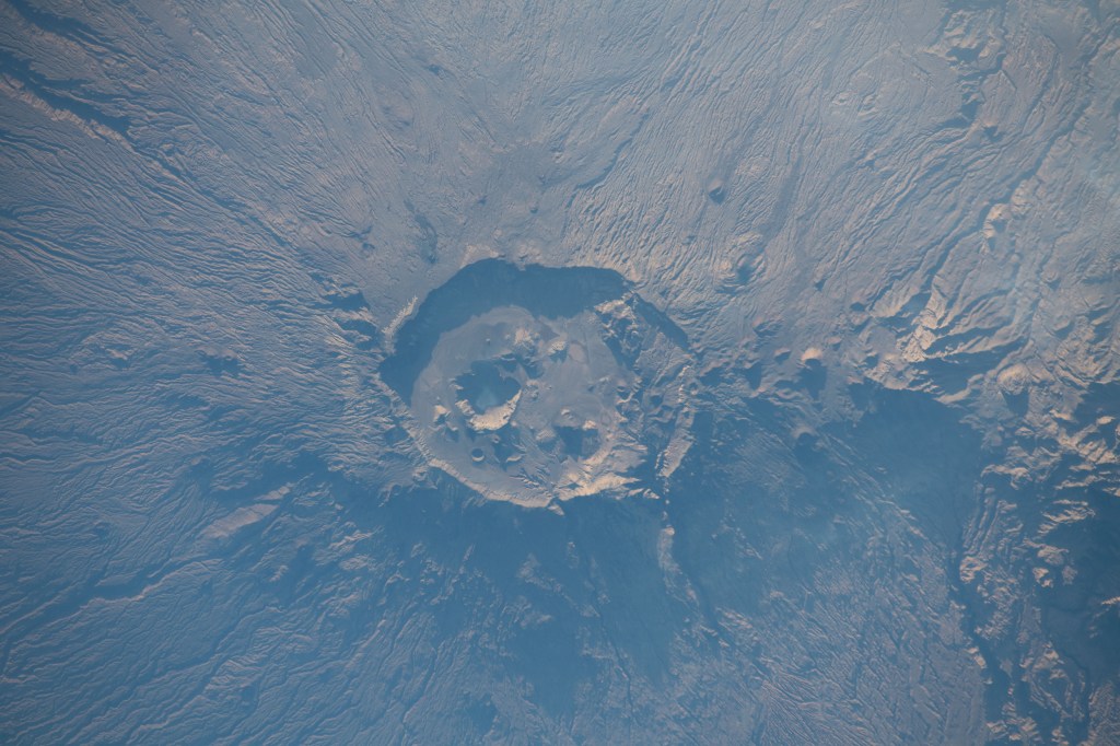 iss068e029498 (Dec. 13, 2022) --- Emi Koussi, a volcano and the highest peak in the Tibesti Mountains of Chad, was photographed from the International Space Station as it orbited 257 miles above Africa.