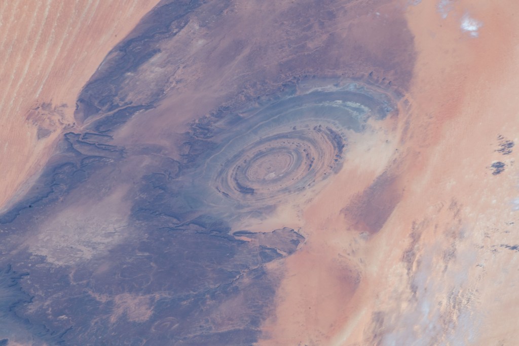 From an altitude of 255 miles, an Expedition 59 crewmember photographed the Richat Structure, or the "Eye of the Sahara," in northwestern Mauritania. The circular geologic feature is thought to be caused by an uplifted dome—geologists would classify it as a domed anticline—that has been eroded to expose the originally flat rock layers.