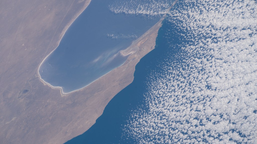 iss068e026839 (Dec. 5, 2022) --- The Garabogazköl Basin, in Turkmenistan on the eastern coast of a cloud-covered Caspian Sea, is pictured from the International Space Station as it orbited 261 miles above.
