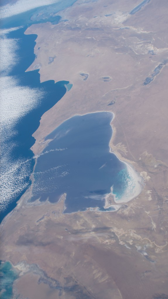 iss068e026829 (Dec. 4, 2022) --- The Garabogazköl Basin, in Turkmenistan on the eastern coast of a cloud-covered Caspian Sea, is pictured from the International Space Station as it orbited 261 miles above.