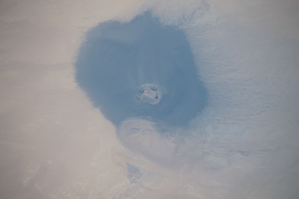 The International Space Station was orbiting 256 miles above the north African country of Libya when an Expedition 59 crewmember photographed the isolated volcanic crater of Waw an Namus, which is composed of dark ash and features three small saltwater lakes.