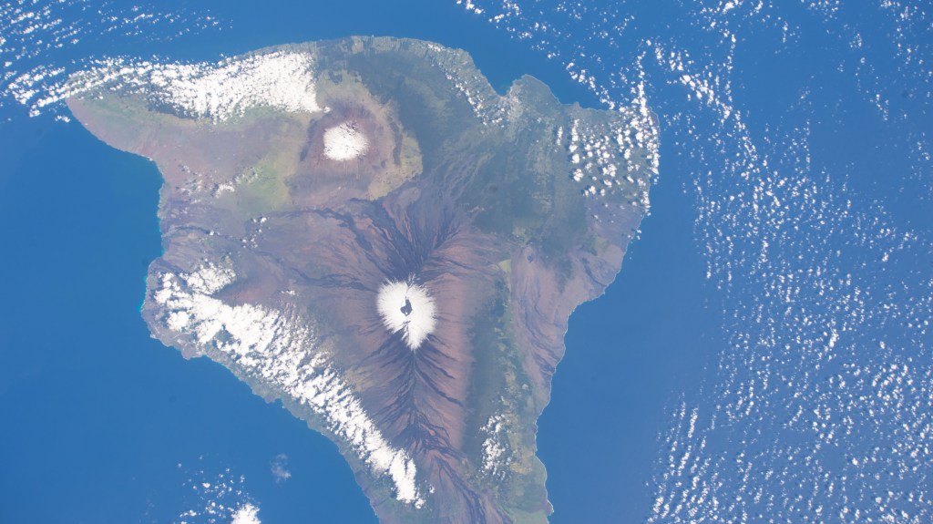 iss068e033632 (Dec. 27, 2022) --- The snow-capped peaks of two different volcanoes on the island of Hawaii, Mauna Loa, an active volcano (bottom), and Mauna Kea, a dormant volcano (top), are pictured from the International Space Station as it orbited 258 miles above the Pacific Ocean.