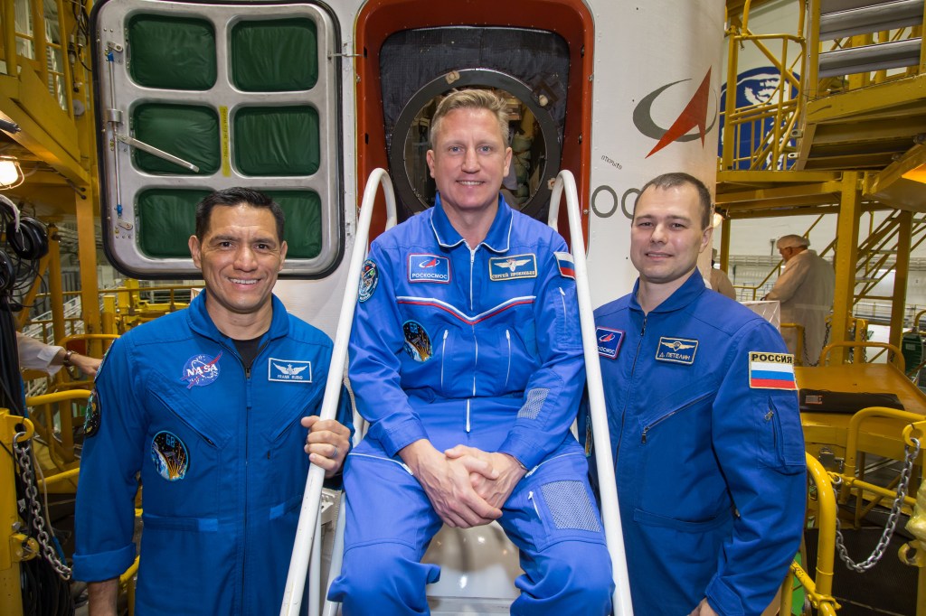 jsc2022e072275 (Sept. 15, 2022) --- At the Baikonur Cosmodrome in Kazakhstan, NASA astronaut Frank Rubio (left), Roscosmos cosmonaut Sergey Prokopyev (center) and Roscosmos cosmonaut Dmitri Petelin (right) complete training preparations in front of their Soyuz MS-22 spacecraft as they prepare for launch Sept. 21 for a six-month mission on the International Space Station. Credit: NASA/Victor Zelentsov.