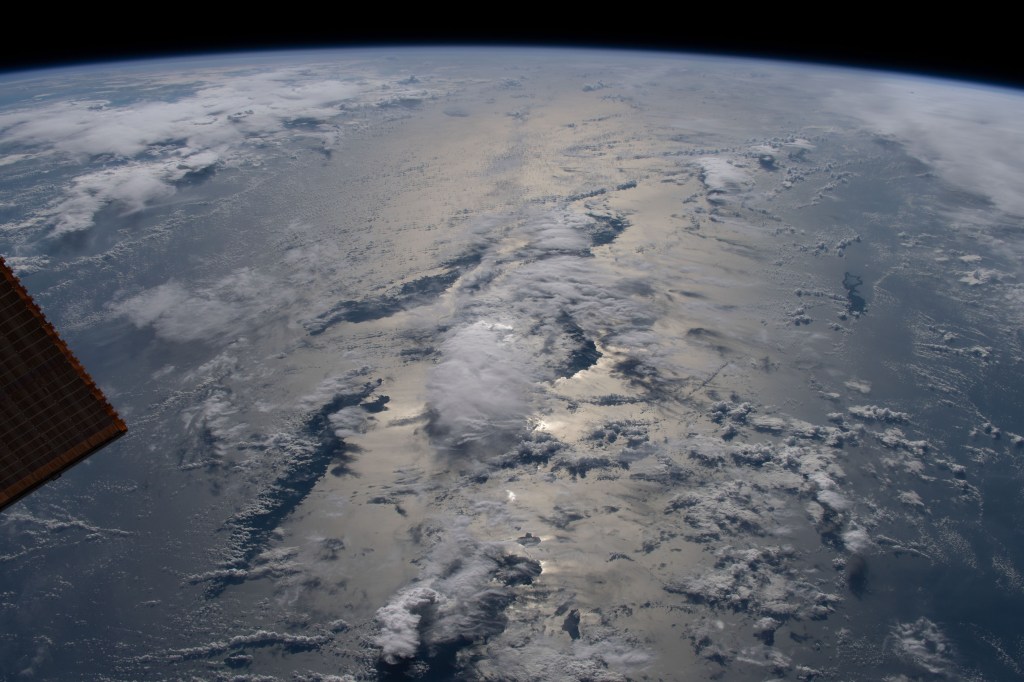iss068e039294 (Jan. 8, 2023) --- The sun's glint beams across the Solomon Sea revealing the cloud-covered Solomon Islands as the International Space Station orbited 259 miles above.