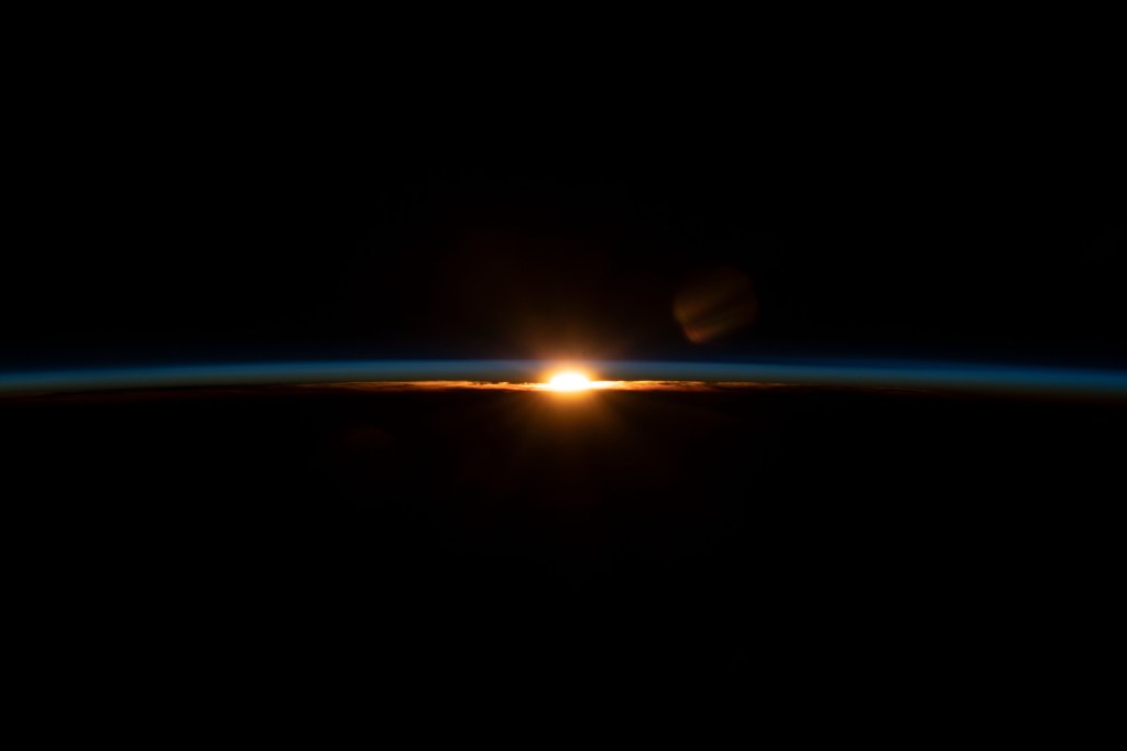 iss068e023088 (Nov. 18, 2022) --- The sun's last rays illuminate Earth's thin atmosphere during an orbital sunset in this photograph from the International Space Station as it orbited 258 miles above the Atlantic Ocean.