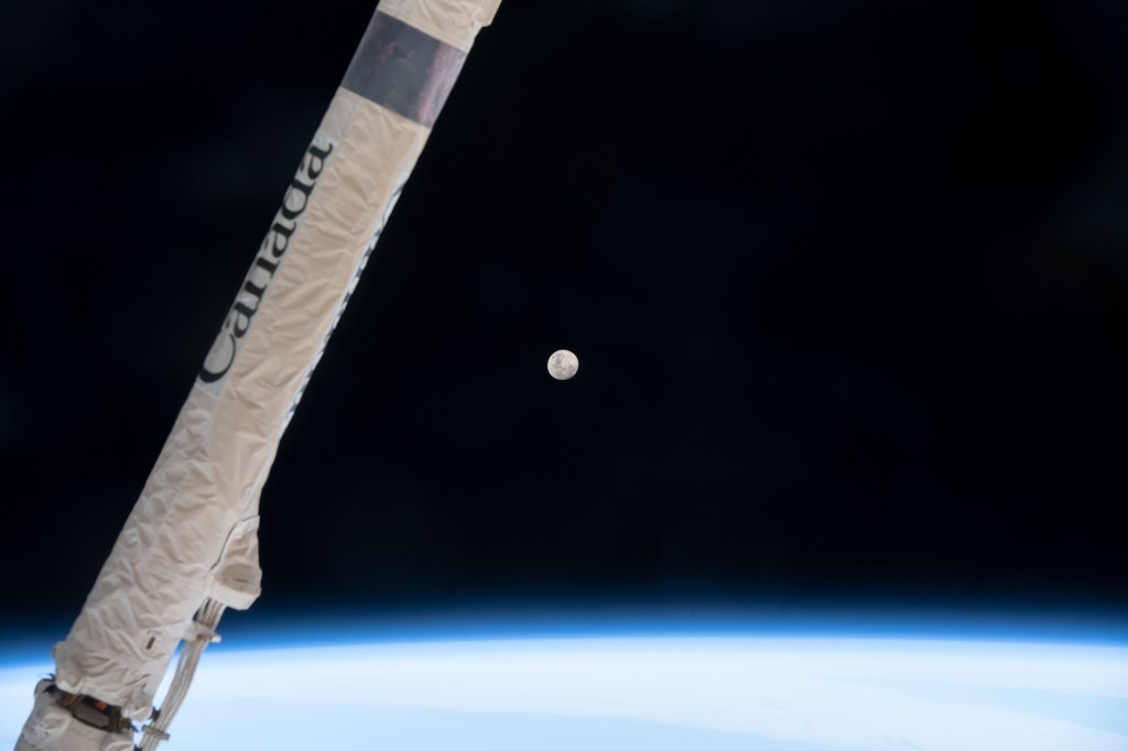 iss068e020765 (Nov. 6, 2022) --- The waxing gibbous Moon is pictured above Earth's horizon as the International Space Station orbited 271 miles over southern Argentina. Crossing the foreground, is a portion of the Canadarm2 robotic arm provided by the Canadian Space Agency.