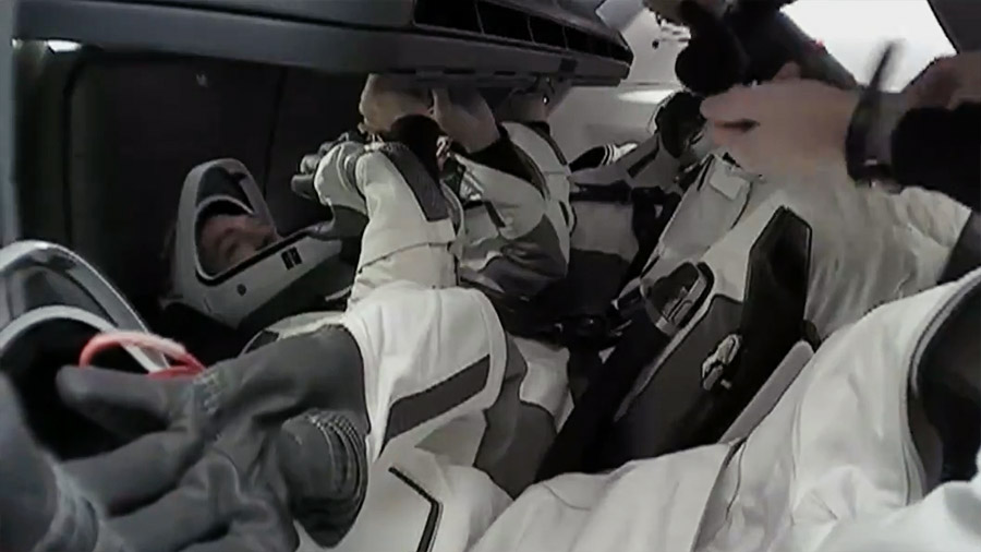 The Axiom Mission 3 crew members are seated inside the SpaceX Dragon spacecraft preparing for their undocking from the International Space Station. Credit: NASA TV