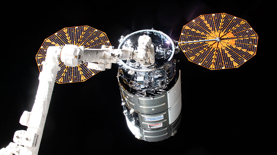 The Cygnus space freighter, with its two cymbal-shaped UltraFlex solar arrays, is pictured in the grips of the Canadarm2 robotic arm after its capture on Feb. 1, 2024.