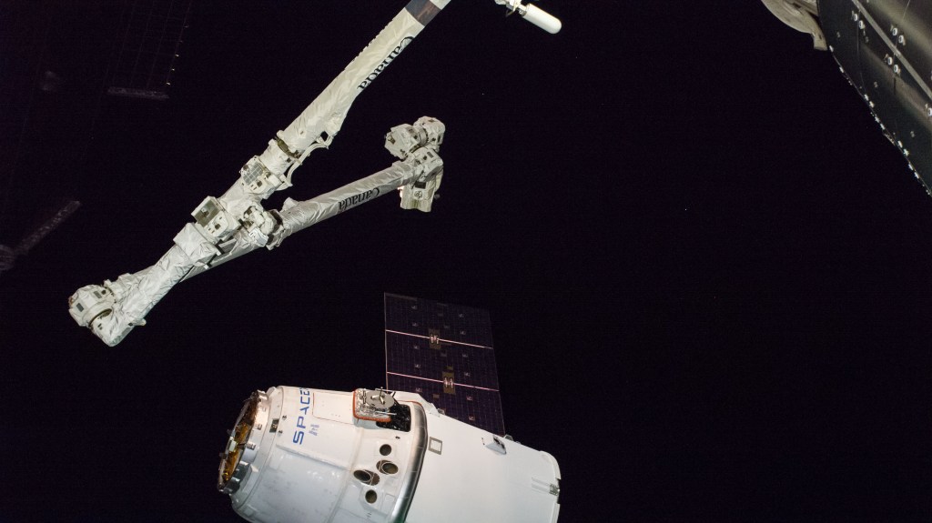 The Canadarm2 robotic arm, operated by astronauts Alexander Gerst and Serena Auñón-Chancellor, slowly reaches out to grapple the SpaceX Dragon cargo craft. Dragon, packed with over 5,600 pounds of cargo, completed a three-day trip to the International Space Station that began with a launch from Cape Canaveral Air Force Station in Florida and ended with its installation and hatch opening on the Harmony module.