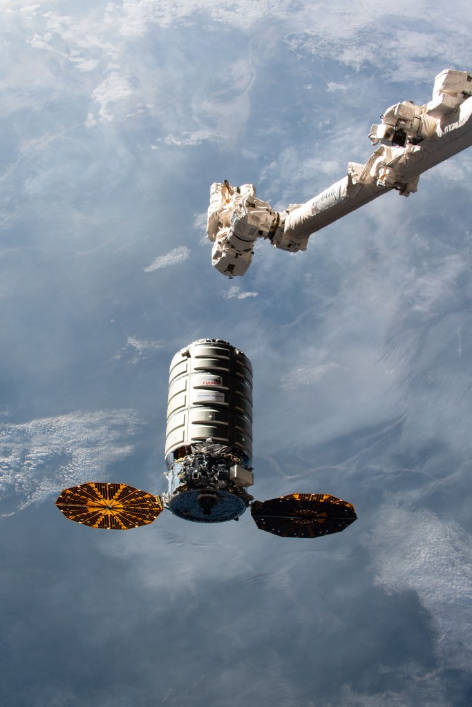 Northrop Grumman's Cygnus space freighter with its prominent cymbal-shaped UltraFlex solar arrays slowly approaches the International Space Station before it's capture with the Canadarm2 robotic arm operated by Expedition 57 Flight Engineer Serena Auñón-Chancellor and ESA (European Space Agency) astronaut Alexander Gerst.