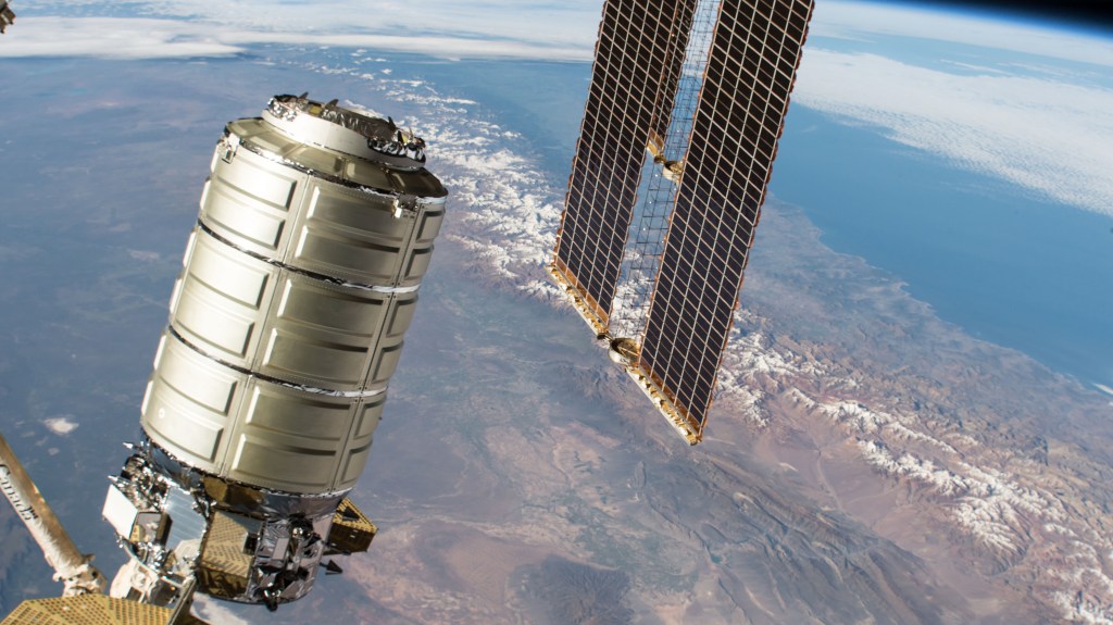 Northrop Grumman's Cygnus space freighter with its prominent cymbal-shaped UltraFlex solar arrays is pictured in the grips of the Canadarm2 robotic arm as it is remotely maneuvered by ground controllers towards the Earth-facing port of the Unity module. Both spacecraft were orbiting 259 miles above the Andes mountains in South America.