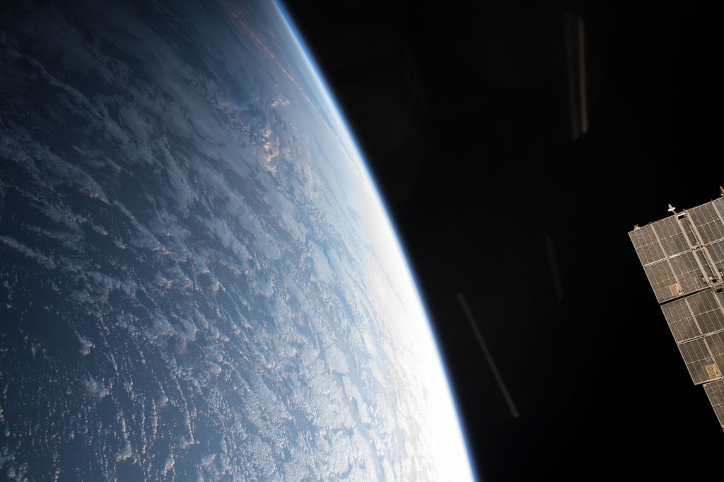 A portion of a Russian solar array peeks out on the side of this photograph of Earth as the International Space Station orbited off the northwest coast of Spain.