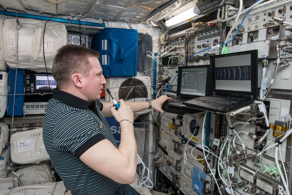 Russian Cosmonaut Sergey Prokopyev, during the Plasma Krystall-4 (PK-4) Experiment. PK-4 is a scientific collaboration between the European Space Agency (ESA) and the Russian Federal Space Agency (Roscosmos), performing research in the field of "Complex Plasmas". Complex or dusty plasmas are plasmas which contain beside electrons, ions, and neutral gas in addition micro-particles, e.g., dust grains. Due to the strong influence of gravity on the micro-particles, most experiments on complex plasmas are strongly distorted or even impossible on earth, and therefore, require microgravity conditions.