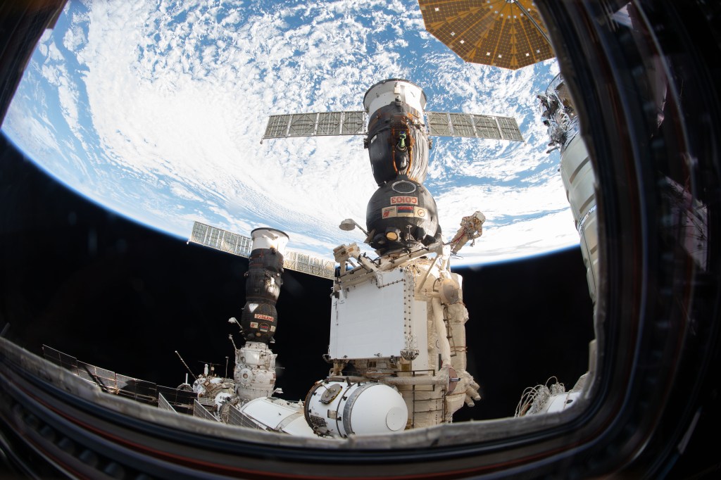 An Expedition 57 crew member inside the cupola photographed Russian spacewalker Oleg Kononenko (suit with red stripes) attached to the Strela boom outside the International Space Station about 250 miles above Earth to inspect the Soyuz MS-09 spacecraft. During the spacewalk, he and fellow spacewalker Sergey Prokopyev (out of frame) examined the external hull of the Soyuz crew ship docked to the Rassvet module. The area corresponded with the location of a small hole inside the Soyuz habitation module that was found in August and caused a decrease in the space station’s pressure. The hole was fixed internally with a sealant within hours of its detection. During the spacewalk, Kononenko and Prokopyev collected samples of some of the sealant that extruded through hole to the outer hull before heading back inside the Pirs docking compartment and closing the hatch completing a seven-hour, 45-minute spacewalk.