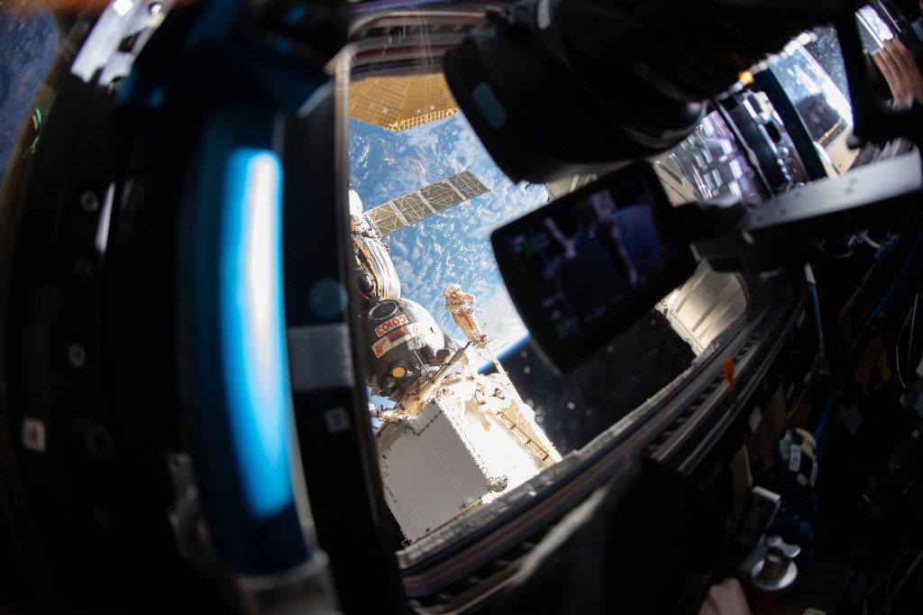 An Expedition 57 crew member inside the cupola photographed Russian spacewalker Oleg Kononenko (suit with red stripes) attached to the Strela boom outside the International Space Station about 250 miles above Earth to inspect the Soyuz MS-09 spacecraft. During the spacewalk, he and fellow spacewalker Sergey Prokopyev (out of frame) examined the external hull of the Soyuz crew ship docked to the Rassvet module. The area corresponded with the location of a small hole inside the Soyuz habitation module that was found in August and caused a decrease in the space station’s pressure. The hole was fixed internally with a sealant within hours of its detection. During the spacewalk, Kononenko and Prokopyev collected samples of some of the sealant that extruded through hole to the outer hull before heading back inside the Pirs docking compartment and closing the hatch completing a seven-hour, 45-minute spacewalk.